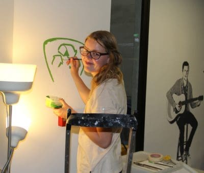 girl painting eco friendly logo acyh